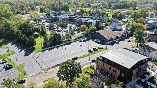 Aerial view of downtown Powell, Ohio, with shops, parking lots and tree-lined streets